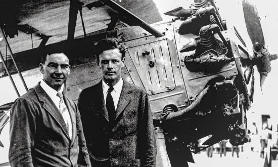 Assistant Secretary David Ingalls, left, and aviation pioneer Charles Lindbergh stand in front of a U.S. Navy “High Hat” aircraft